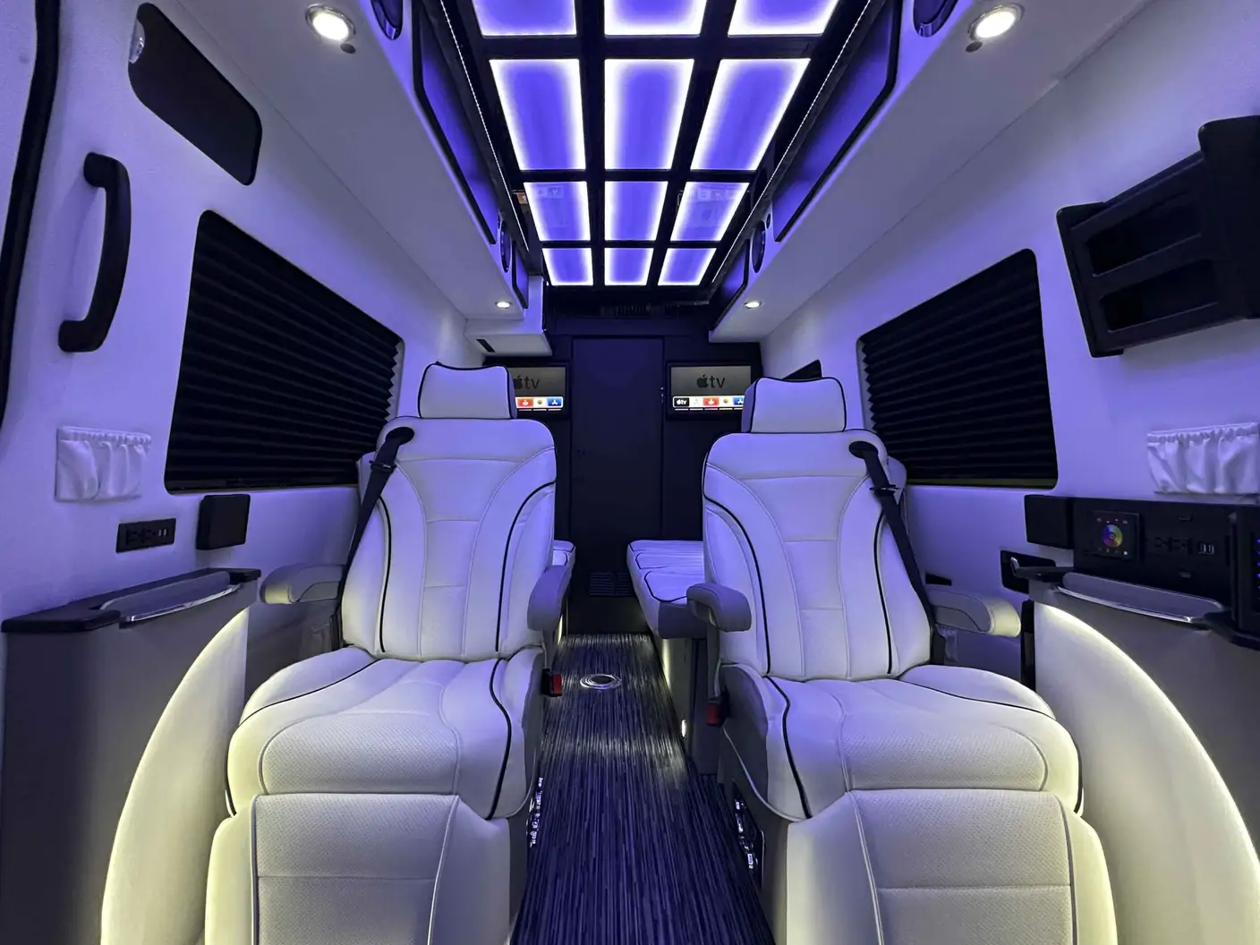 Luxury sprinter van interior with custom seating and ambient lighting