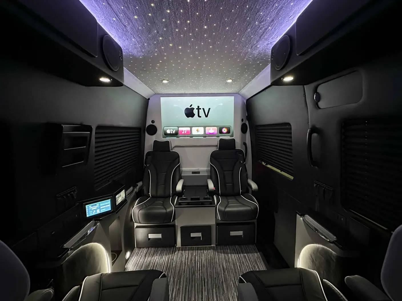 Sprinter van interior with stereo upgrade, featuring Mercedes speakers and entertainment setup