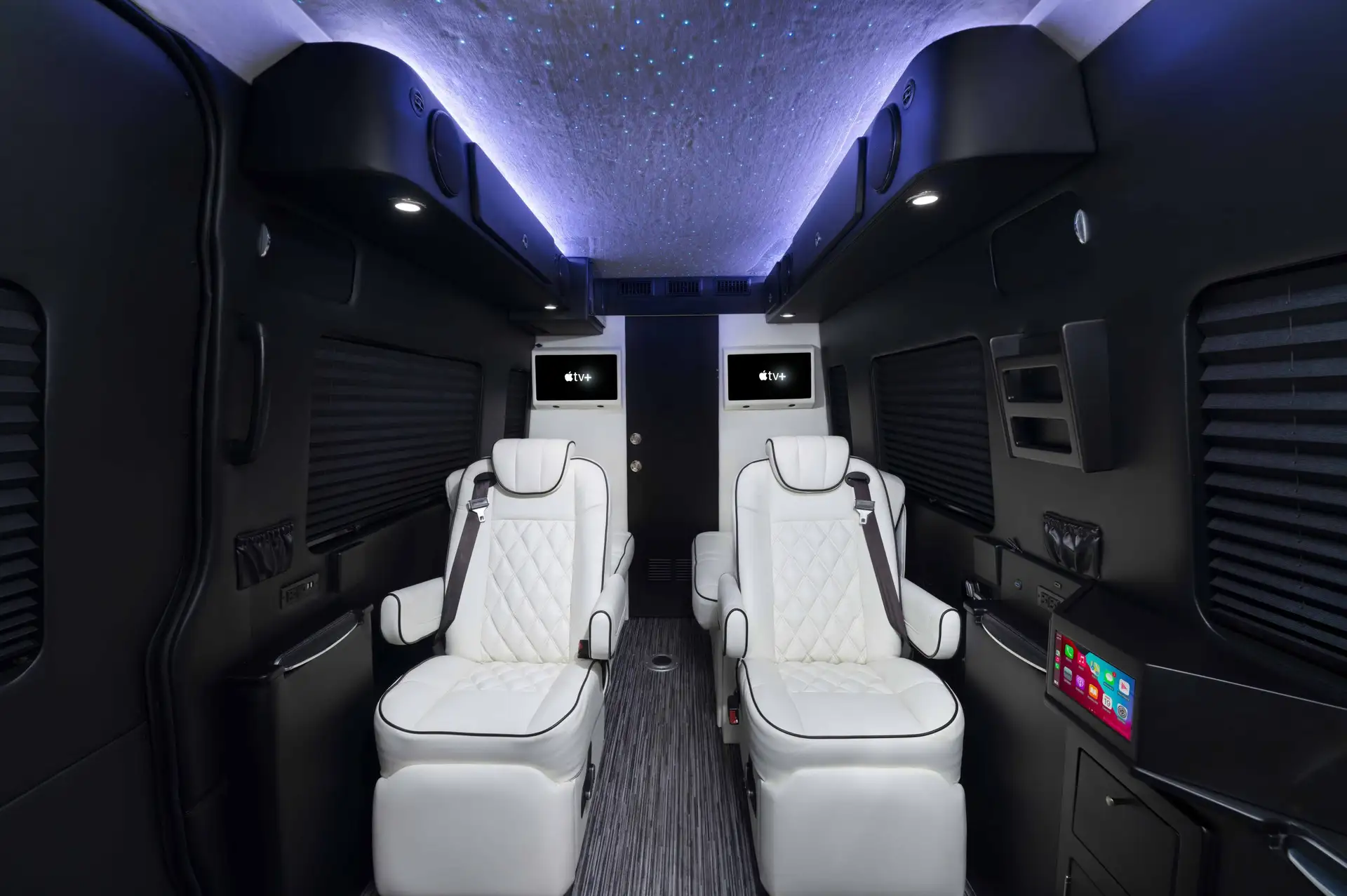 Custom van interiors with luxury seating in a Mercedes Sprinter van.